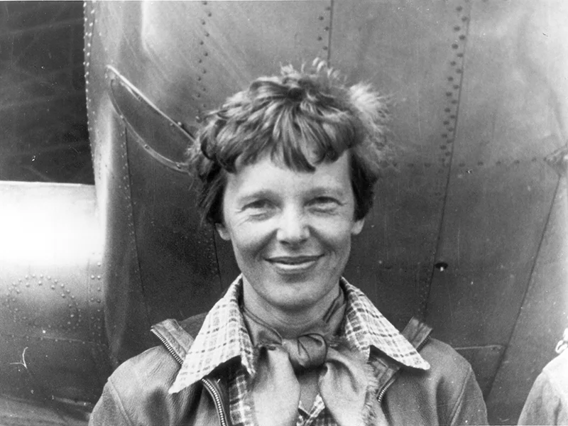 Amelia Earhart in front of her aircraft's fuselage, archive photograph