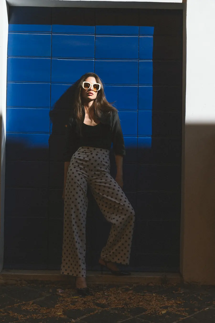 A model standing in front of a blue door